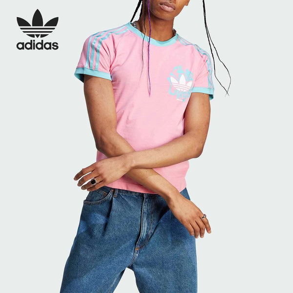 Pink Adidas T-shirt with light blue trims and Trefoil logo, styled casually with jeans