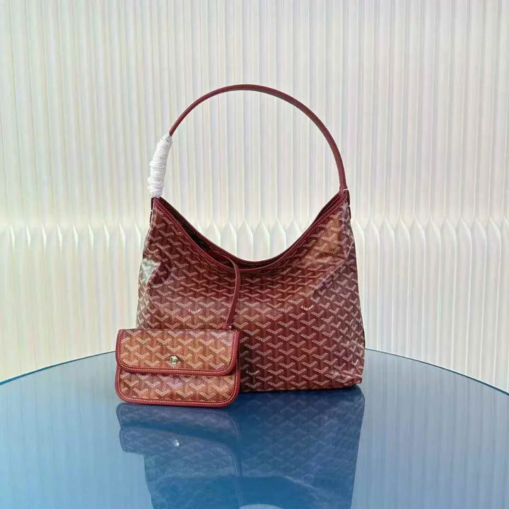 luxury geometric pattern hobo bag حقيبة كتف with leather strap on blue table
