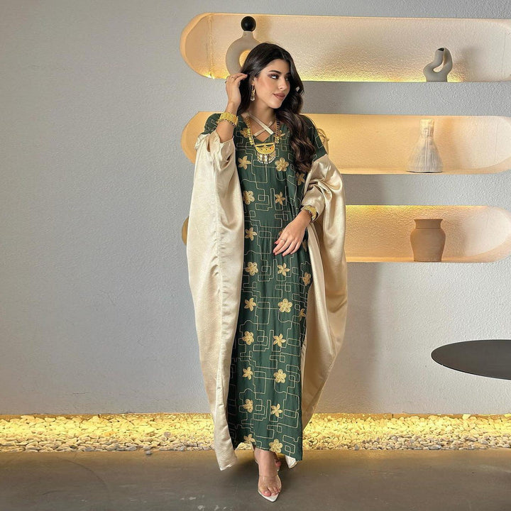 Luxury dress with golden patterns and satin cape for elegant occasions.