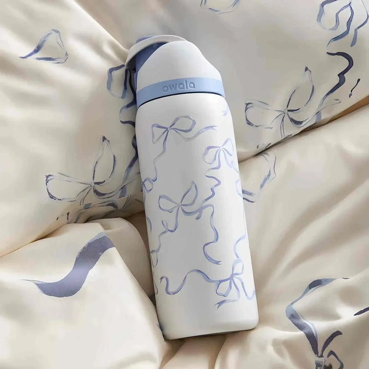 Owala FreeSip water bottle with cute bow design, leak-proof and dual sipping spout, keeps drinks cold for 24 hours, BPA-free