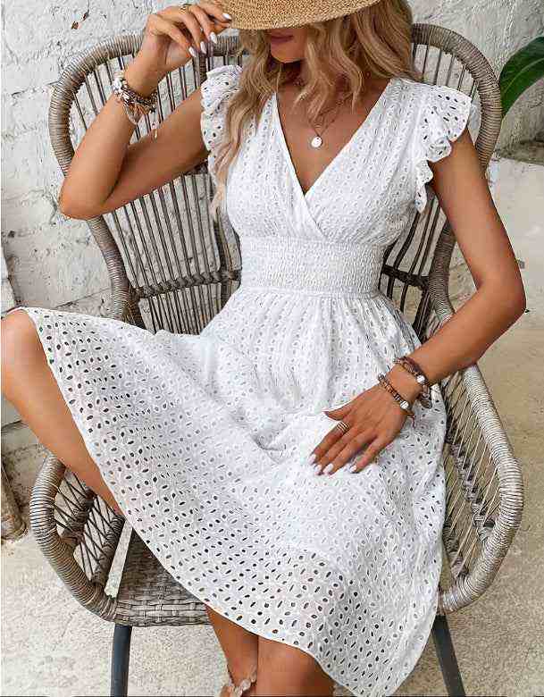 Elegant white V-neck dress with ruffle sleeves and cut-out design, showcasing plus-size women's summer fashion.