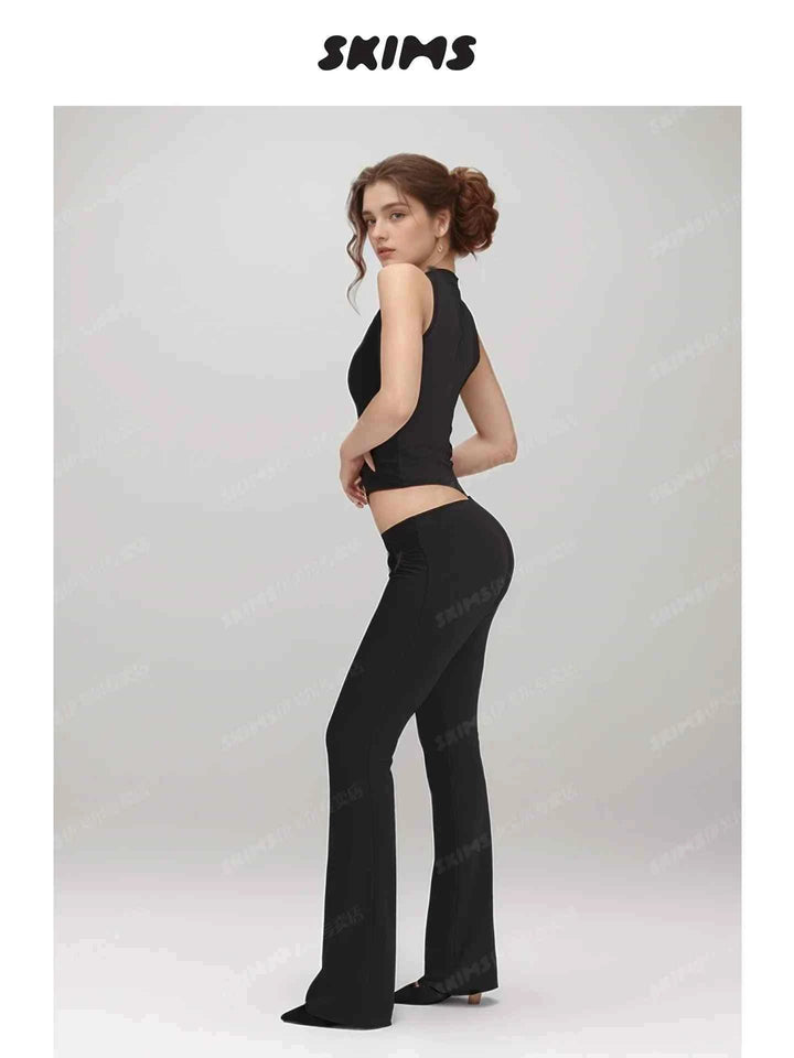 SKIMS Kardashian black sleeveless top and fitted pants set with heart-shaped cutouts