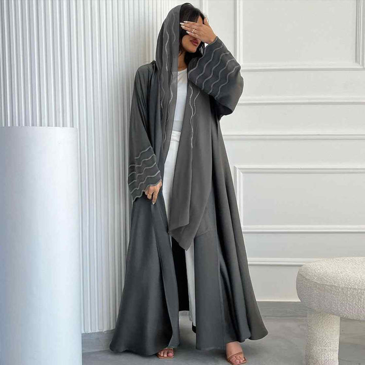 Elegant abaya with modern design and wavy sleeve accents, paired with matching hijab.