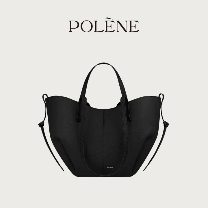Black Polène Cyme Mini leather tote bag with soft curves, dual carrying straps, and gold logo detail.