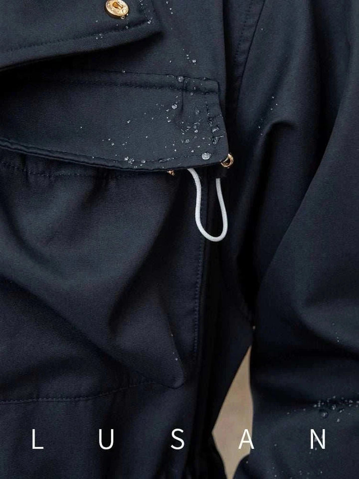 Close-up of black water-resistant Mr. Lusan Jacket with metal details and adjustable waist cords