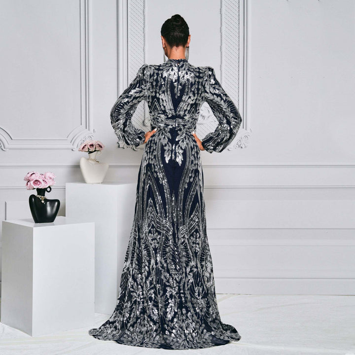 Elegant sequined evening dress with puffed sleeves and fitted waist for a regal look.