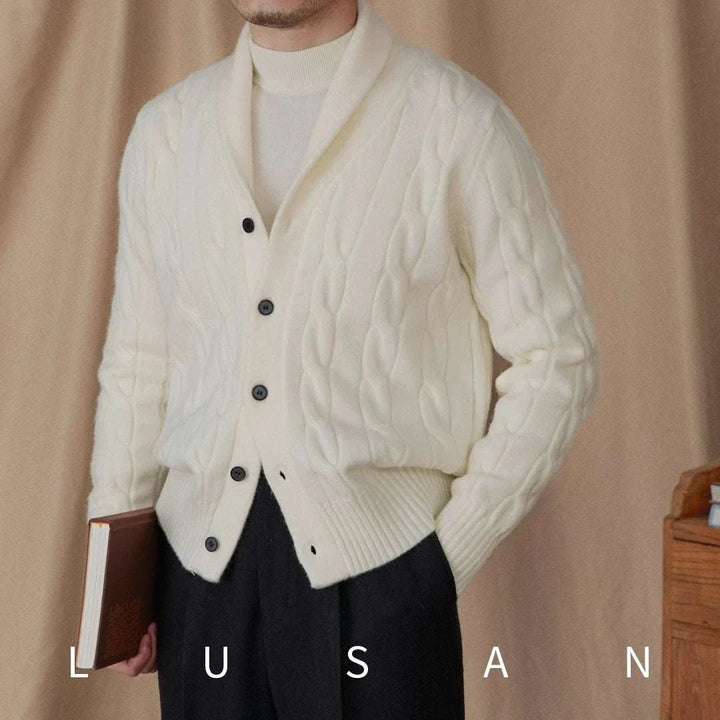 Mr. Lusan cream shawl collar cardigan with cable knit and black buttons worn by man holding book