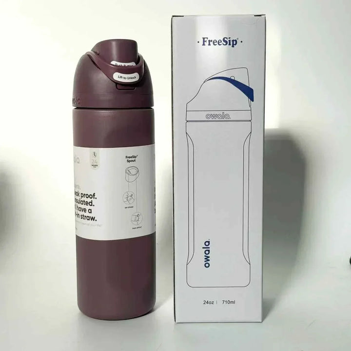 Owala FreeSip insulated stainless steel water bottle with dual spout and leak-proof design in maroon color next to its packaging box