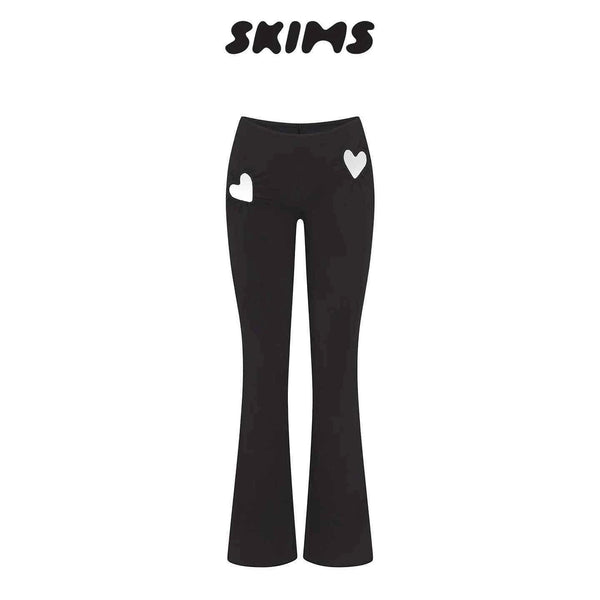 Black SKIMS Kardashian women's fitted pants with high waist and heart cut-out details on hips