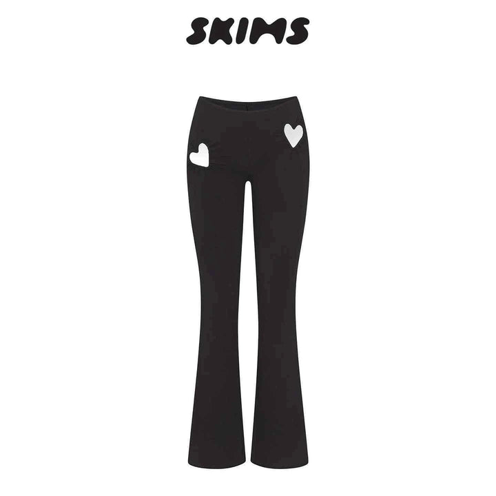 Black SKIMS Kardashian women's fitted pants with high waist and heart cut-out details on hips