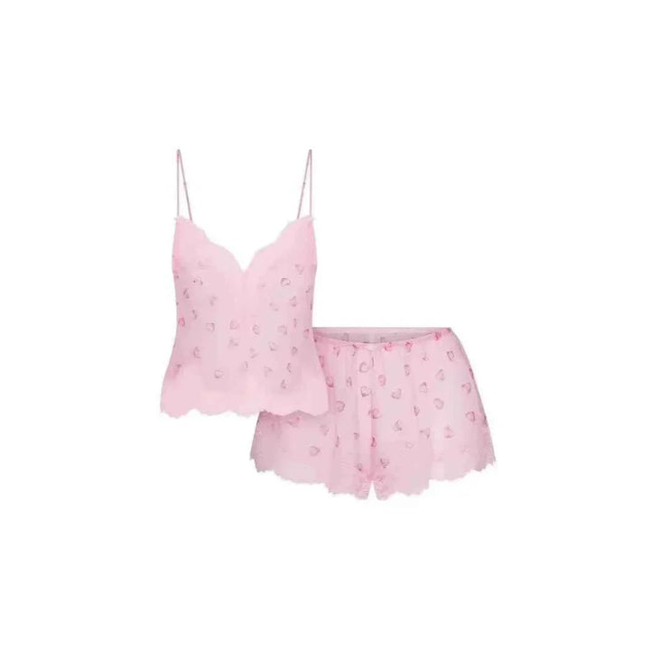 Pink lace heart pattern SKIMS sleep set with camisole and shorts, lightweight and romantic design.