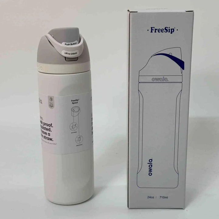 Owala FreeSip stainless steel water bottle with dual spout and leak-proof design next to its packaging box