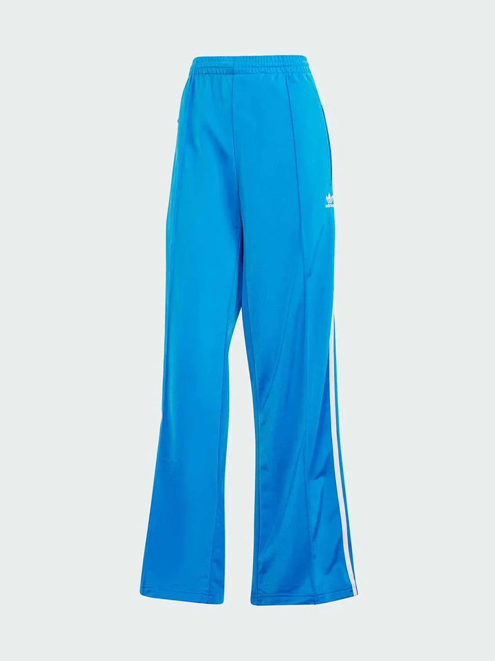 blue Adidas sports pants with classic white stripes, soft lightweight fabric, wide fit, side zip pockets, ideal for daily wear and workouts