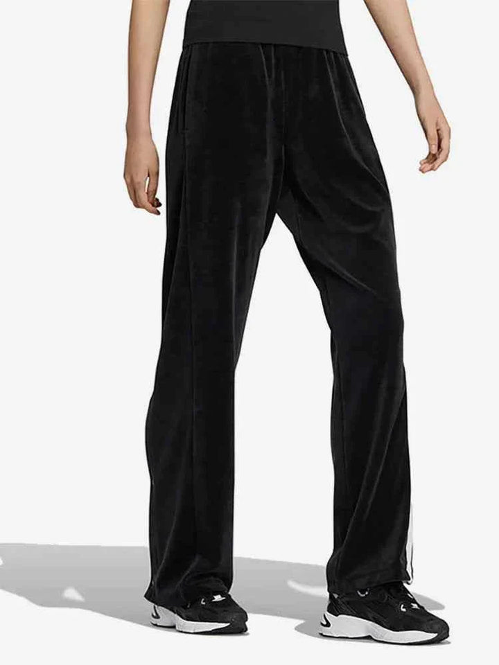 black Adidas sports pants with classic design and white side stripes