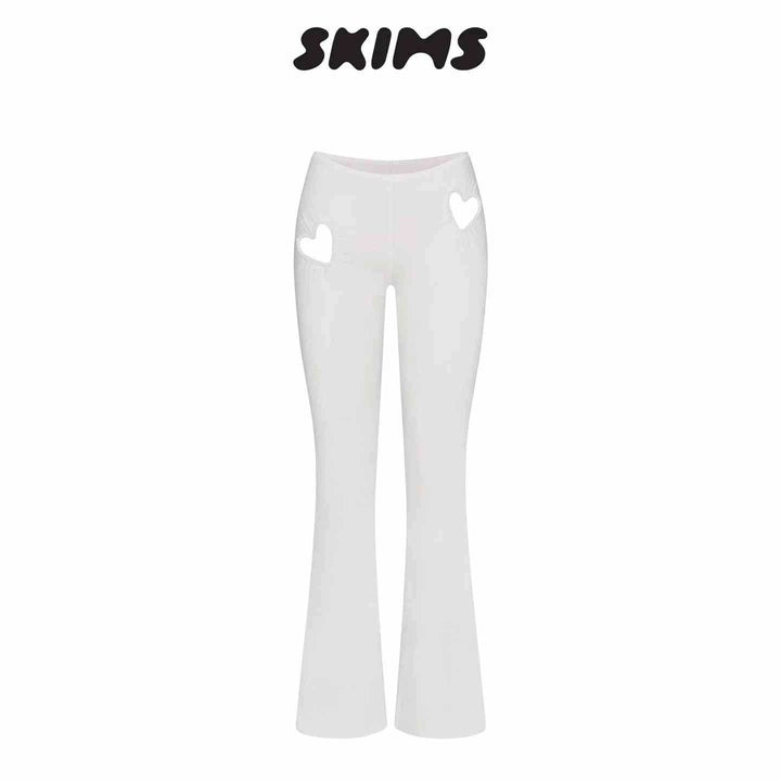 White SKIMS Kardashian women's slim pants with high waist and heart-shaped cutouts on hips