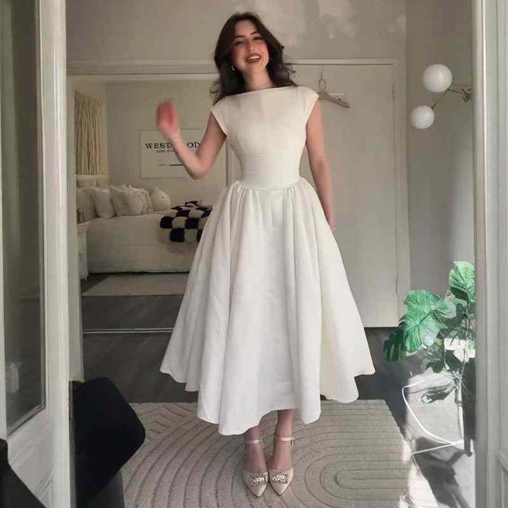 Elegant white vintage-inspired classic dress with fitted waist and wide A-line skirt, perfect for 2025 summer formal events.