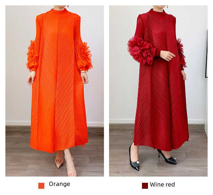 Long loose dress with flower-adorned sleeves and pleats in orange and wine red colors.