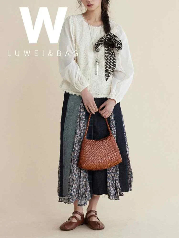 woman holding brown dragon woven bag made of natural cow leather with braided design