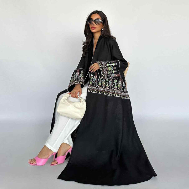 Elegant embroidered abaya with traditional design, featuring intricate patterns on sleeves and hem, perfect for a sophisticated look, available in multiple colors.