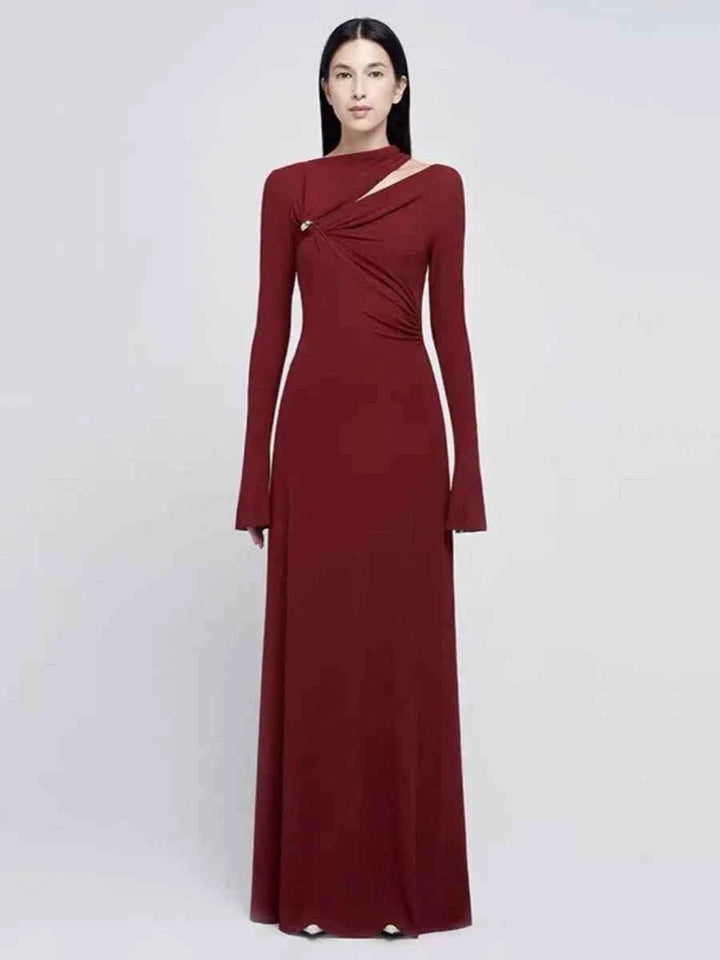 Elegant red long sleeve evening maxi dress with asymmetrical neckline and silver pin detail