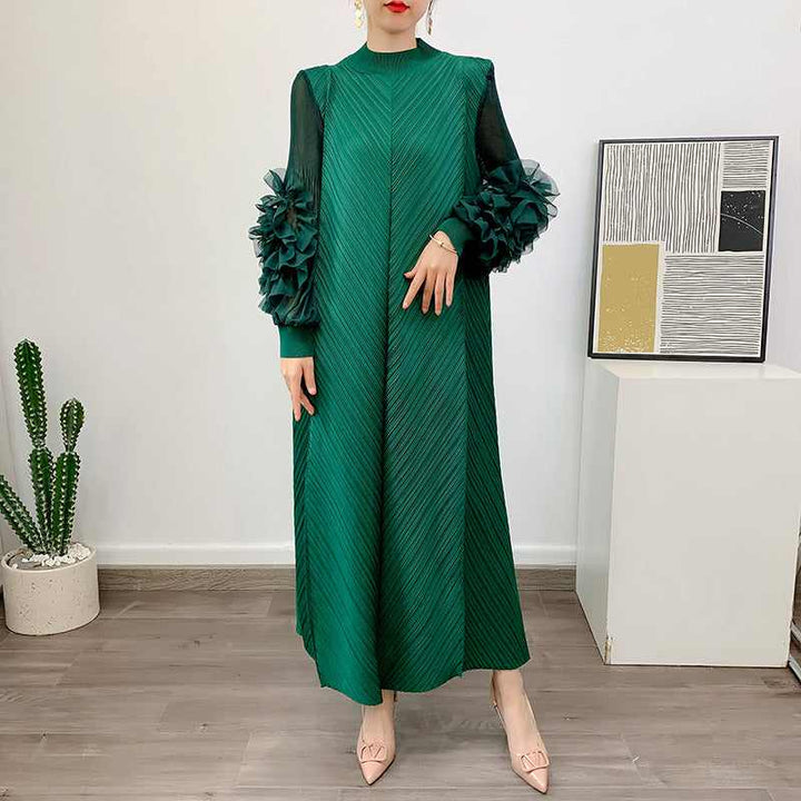 Elegant green dress with floral embellished transparent sleeves, featuring a loose fit and diagonal pattern.