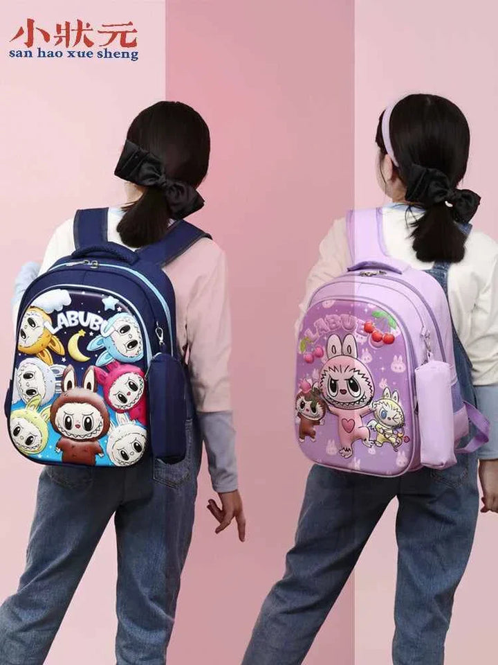 Two girls wearing colorful LABUBU cartoon backpacks in navy blue and lavender, standing against a pink wall.