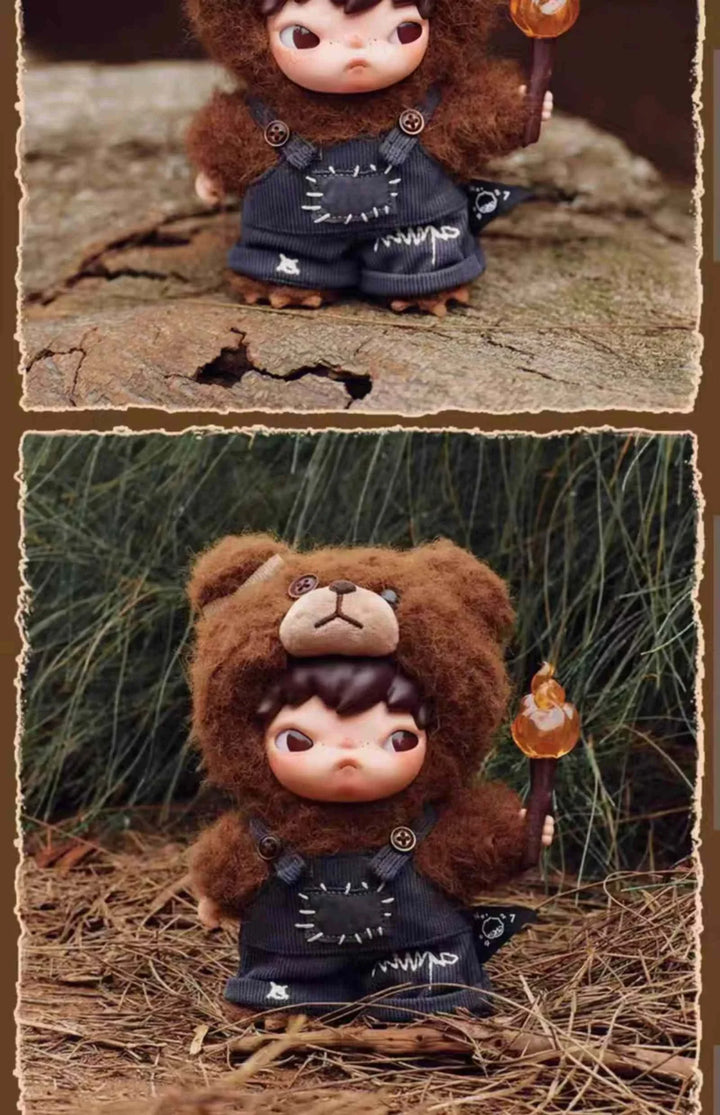 POPMART Hirono Living Wild Fight for Joy plush doll in dark brown bear costume holding a fire torch, detailed with embroidered black clothing and button accents.
