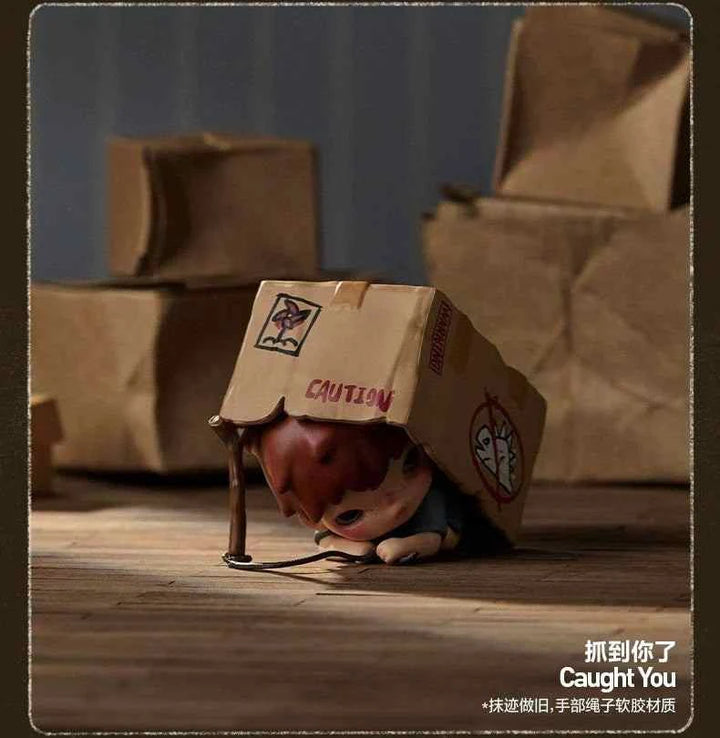 POP MART Hirono Echo Series figurine depicting a child under a cardboard box with "Caught You" text.