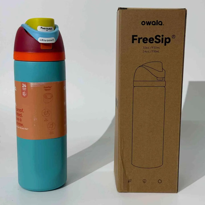 Owala Thermos CupKitty Limited Edition stainless steel insulated water bottle with dual drinking spout and leak-proof design next to its cardboard packaging box