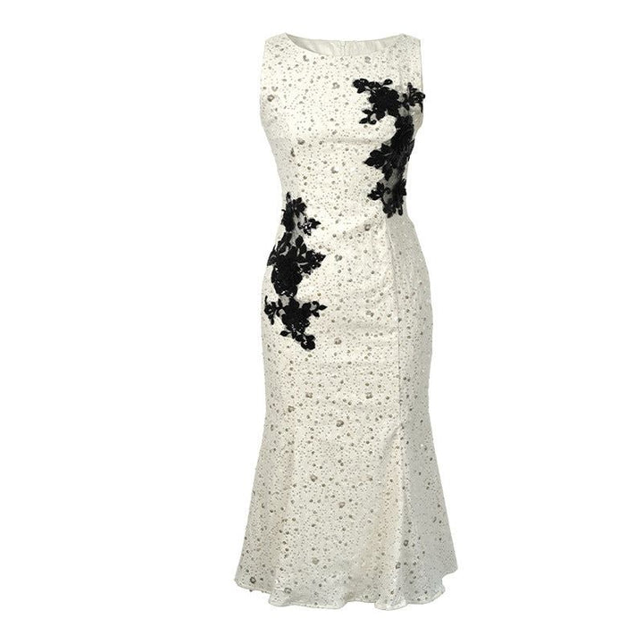 Elegant lace gown with sequin embellishments and 3D floral embroidery, featuring a fitted waist and mermaid-style skirt.