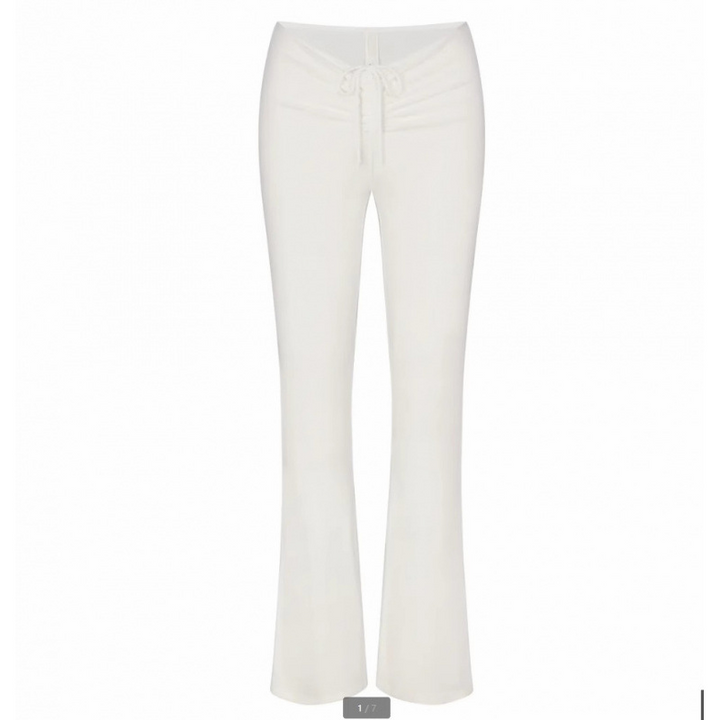 White SKIMS wide leg lounge pants with adjustable drawstring waist for comfortable casual wear