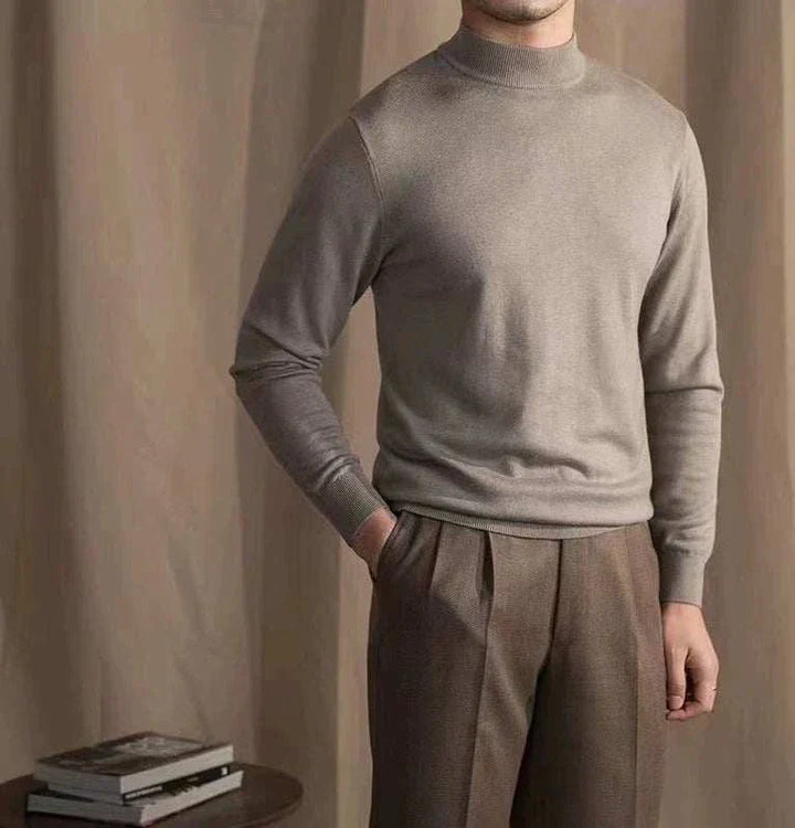 Mr. Lu San's 30% wool slim fit half-high neck sweater in beige worn with brown trousers