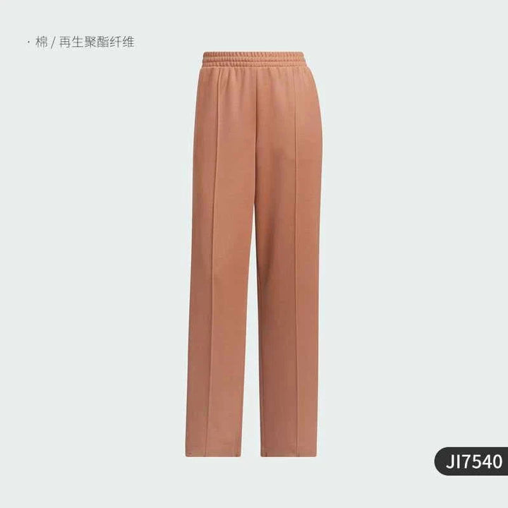 Adidas wide fit brown sports pants with elastic waistband and smooth fabric, featuring classic three stripes design.