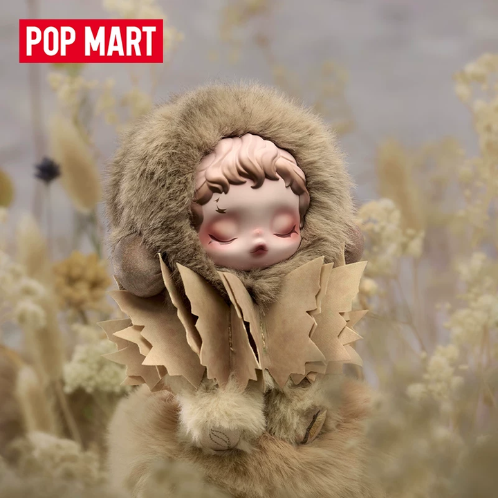 POP MART OSKULLPANDA collectible doll with fur hood and intricate beige outfit in a natural setting