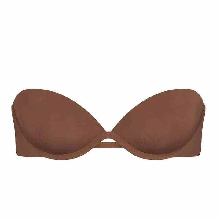 SKIMS Multi-Way Strapless Bra in cocoa brown with smooth finish, adjustable detachable straps, and side wings for secure support.