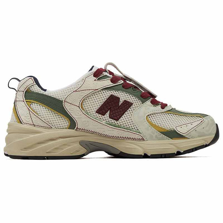 New Balance 530 sneaker in beige, olive green, and dark red with mesh and leather details, limited edition PandaPrank design