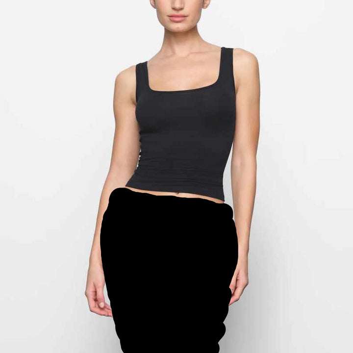 Woman wearing black SKIMS توب برقبة مربعة square neck tank top and matching underwear against white background