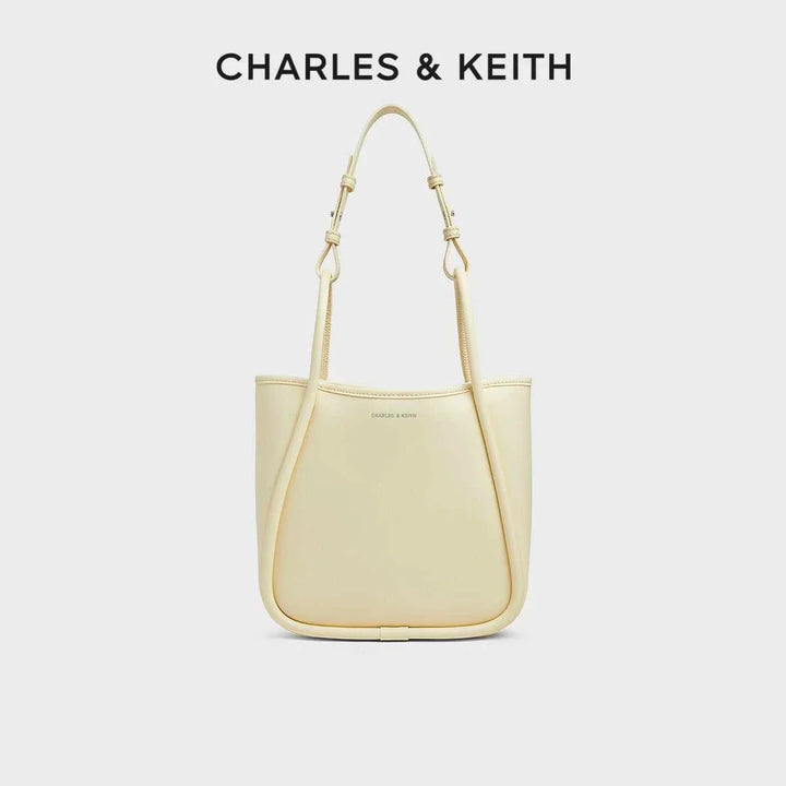 CHARLES & KEITH beige multi-color shoulder bag with adjustable straps and durable synthetic leather design