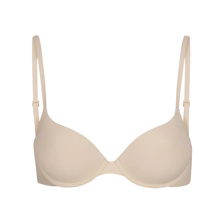 Soft supportive beige bra with smooth seamless design and adjustable straps for everyday comfort and natural shape.