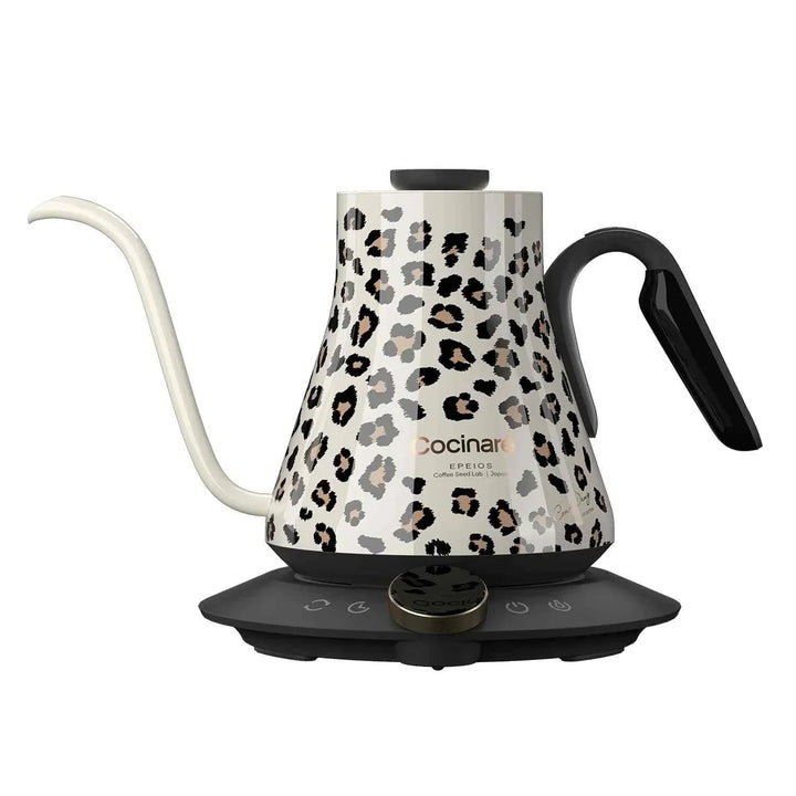 Electric Cocinare kettle with leopard print design, S-shaped spout, ergonomic handle, and digital base for precise temperature control.