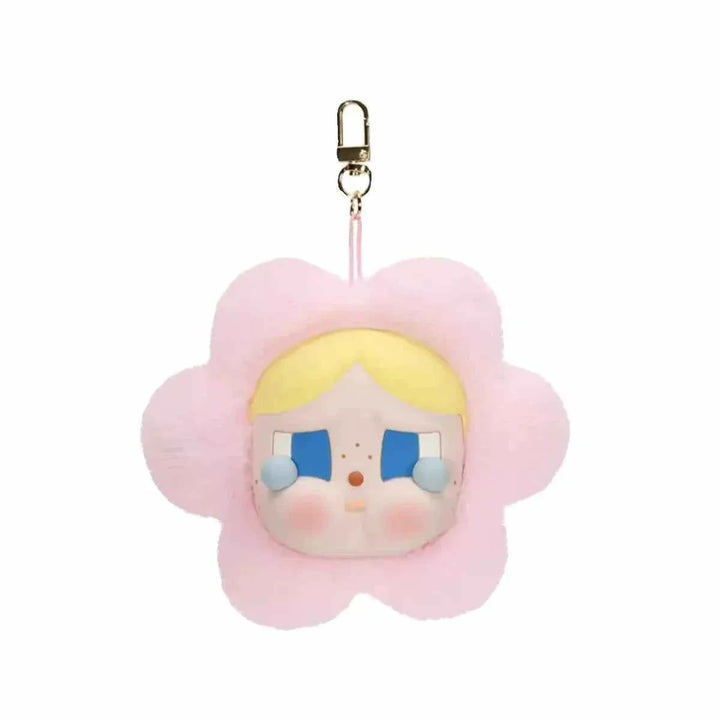 Soft pink Crybaby plush keychain with a crying face and yellow hair, part of the مجسمات Crybaby collection.