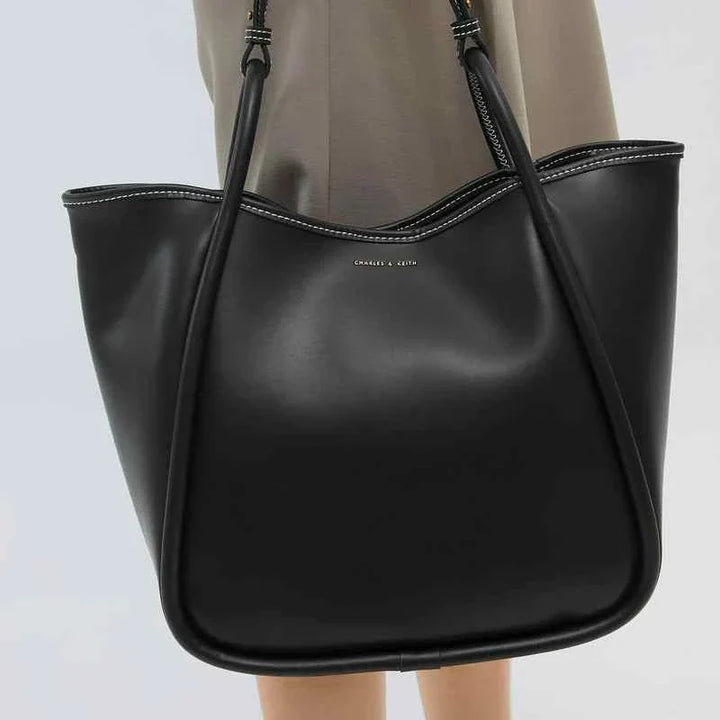 Black large leather shoulder bag by CHARLES & KEITH with adjustable strap and gold logo