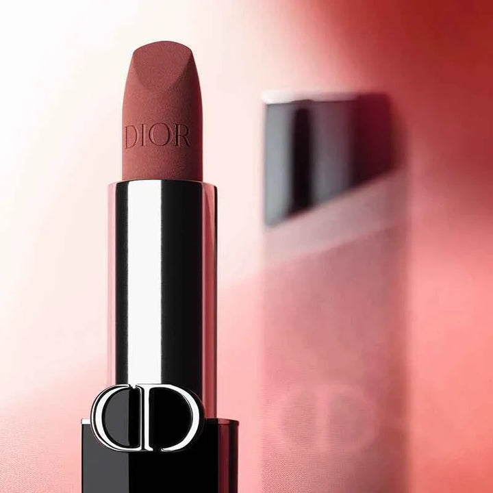 Rouge Dior classic lipstick in elegant deep red shade with silver and black casing on pink background