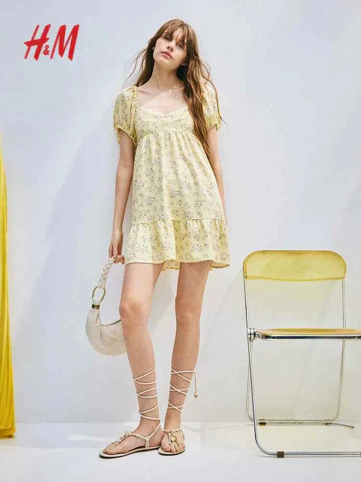Yellow puff-sleeve dress with sweetheart neckline and flared skirt by H&M.اتش اند ام