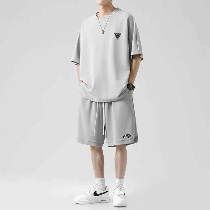 Men's Ice Silk set with loose T-shirt and practical shorts in light gray, made from soft wrinkle-resistant fabric for summer comfort and style