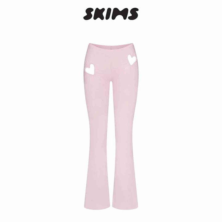 Pink SKIMS Kardashian women's fitted pants with heart-shaped cutouts on hips and high waist design