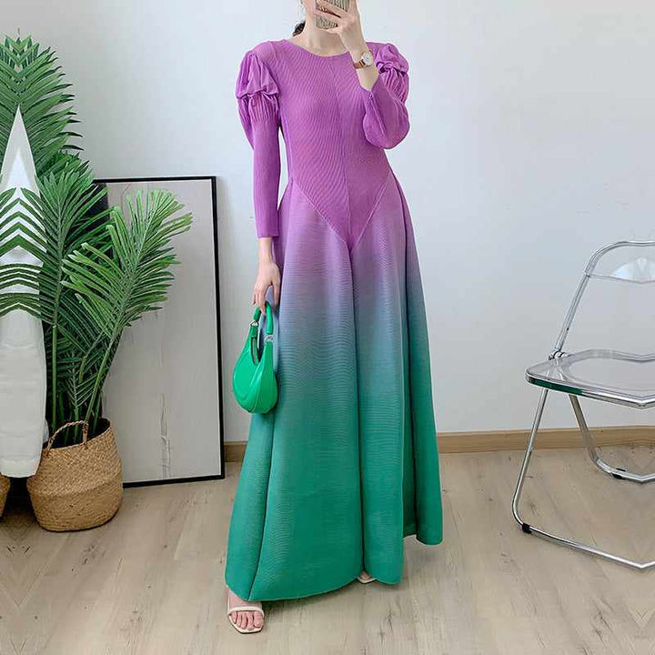 Long sleeve gradient dress with pleated shoulders and flowing design.