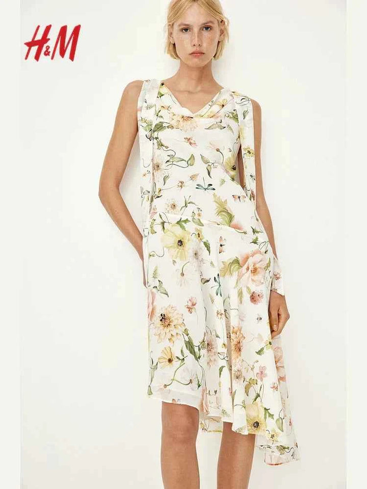 H&M floral midi dress with round neckline and asymmetrical hem.