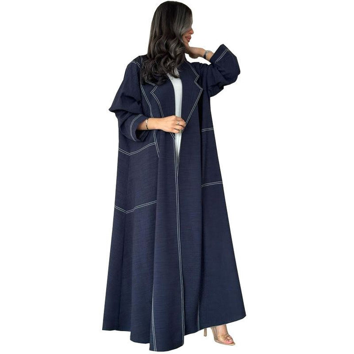 Wide navy abaya with elegant ruffles and visible stitching, featuring loose comfortable sleeves for a chic and sophisticated look.