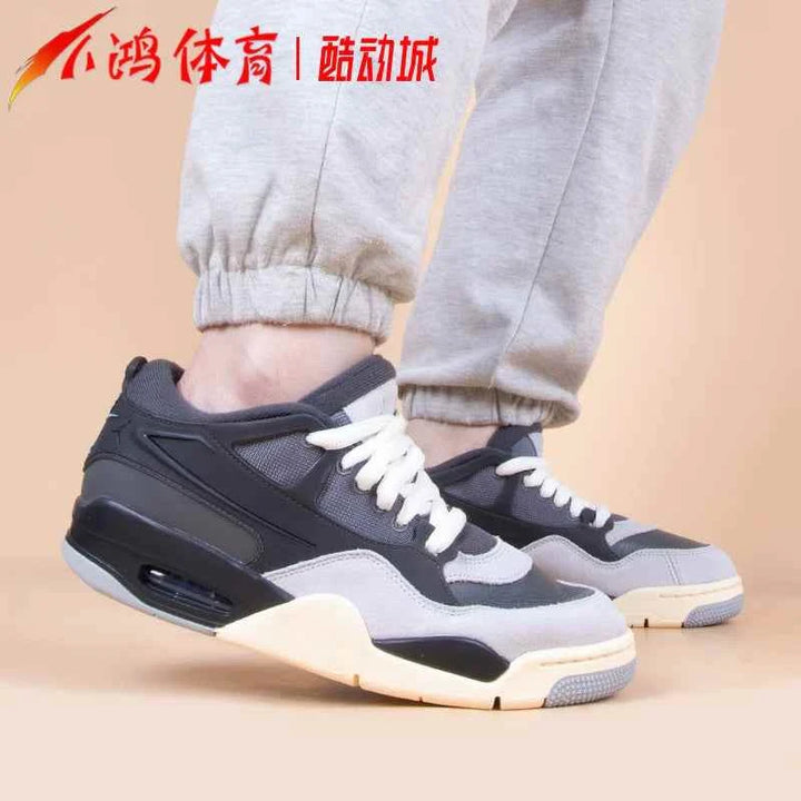 Air Jordan 4RM sneakers in iron gray and chambray on feet.